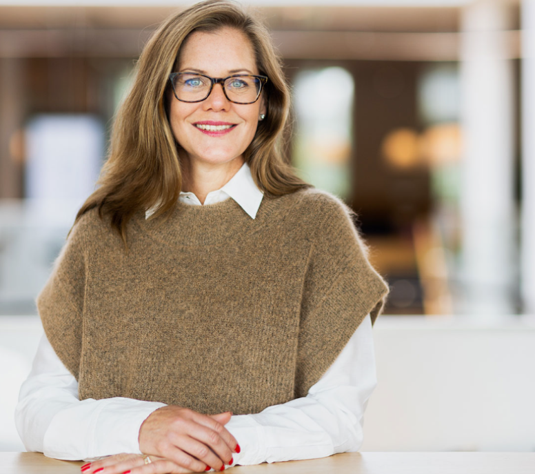 person wearing suit reading business newspaper